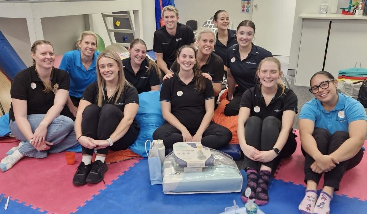 The Little Achievers team sitting together in the clinic